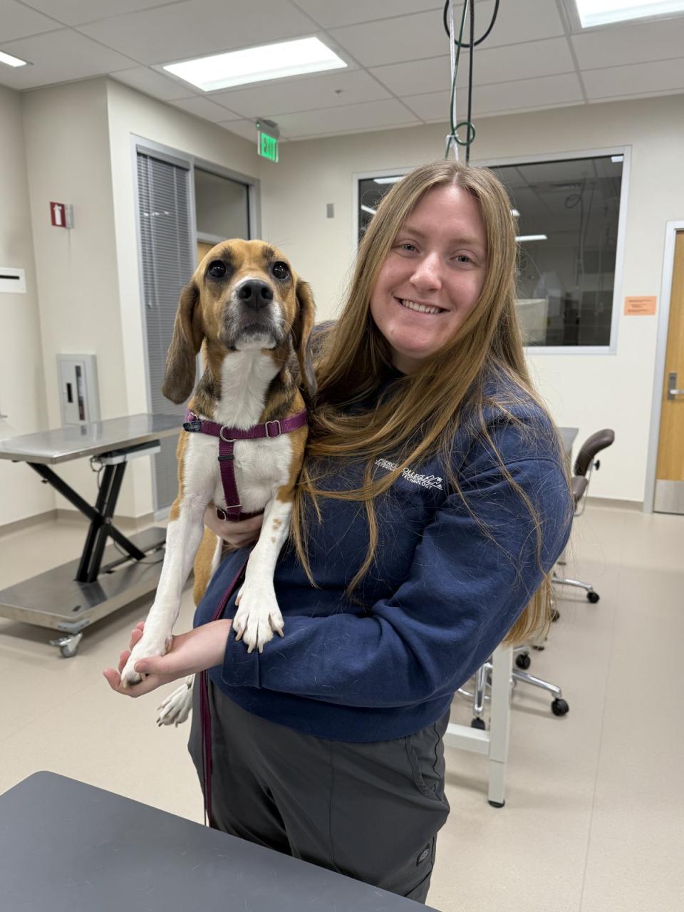 Kenzie Williams smiling while holding a dog.